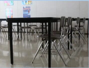 Empty classroom desks and tables